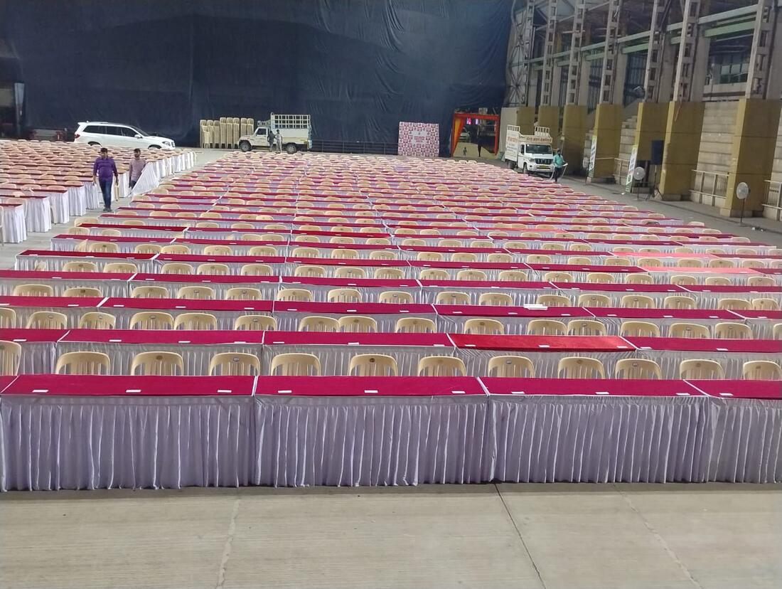 Long rows of draped banquet tables and chairs set for a large gathering