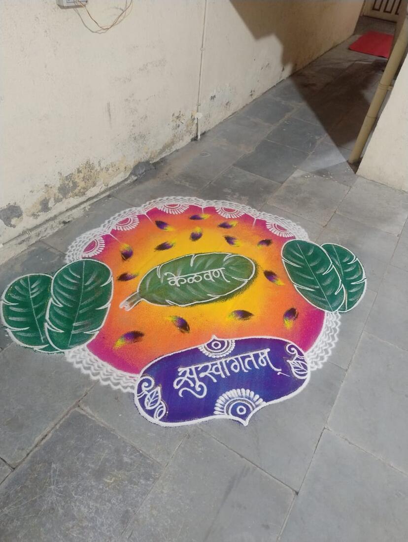 A hand-drawn rangoli welcoming guests at the entrance